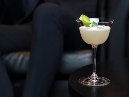 cocktail in glass with black background