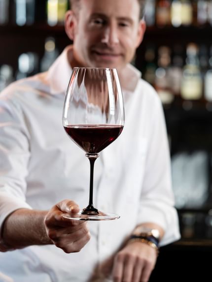 holding red wine glass