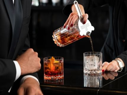 pouring whisky into glasses
