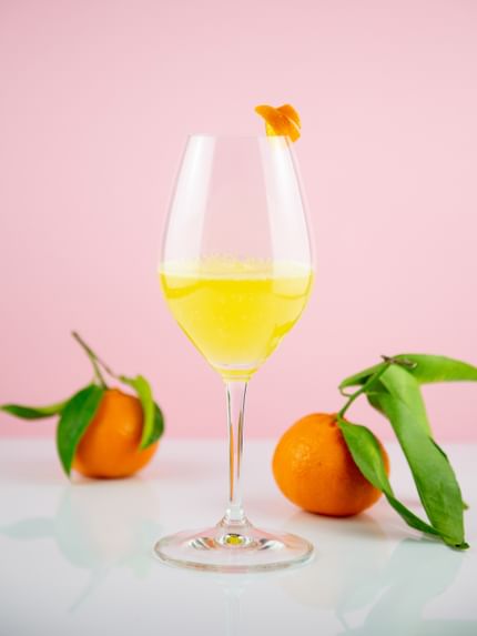 mimosa mocktail next to oranges