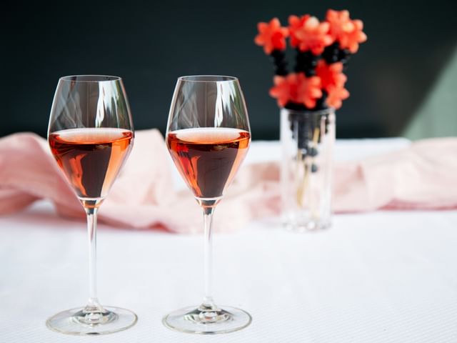 two champagne wine glasses on table with flowers