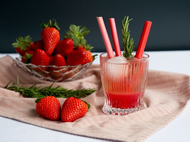 strawberry drink next to bowl of strawberries