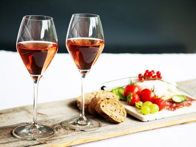 Two RIEDEL wine glasses and vegetable tray