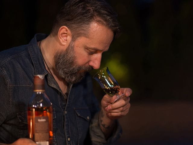 Man sniffing whisky out of the RIEDEL Sommeliers Single Malt Whisky glass.