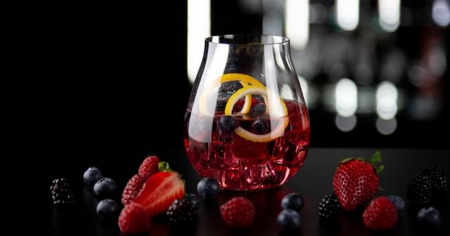 berry cocktail surrounded by berries
