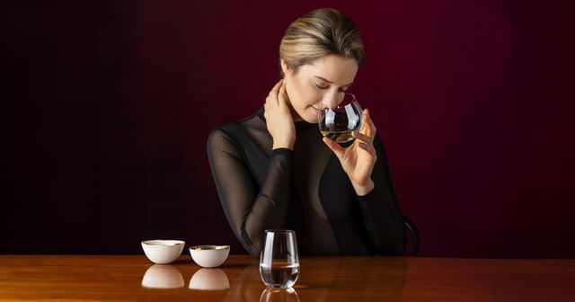 woman holding RIEDEL The O Wine Tumbler glass