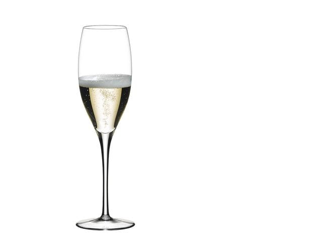 RIEDEL Veritas Champagne Flute filled with Champagne on a white background.
