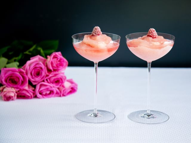 two frozen cocktails on table top with black background