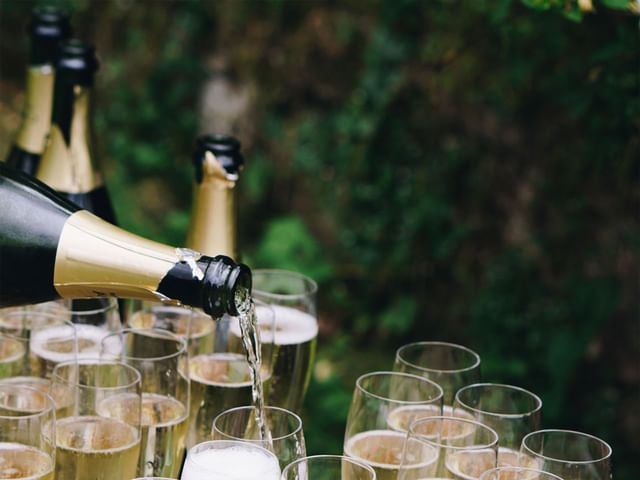 Champagne being poured into Champagne glasses.